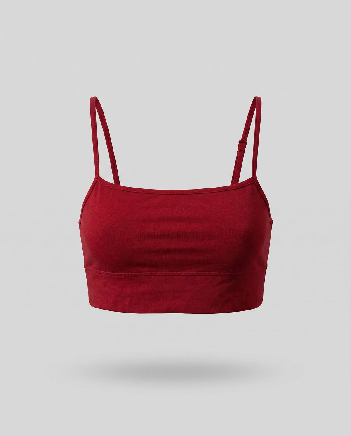 A KAYA cherry red straight-neck bra top on a pale grey backdrop