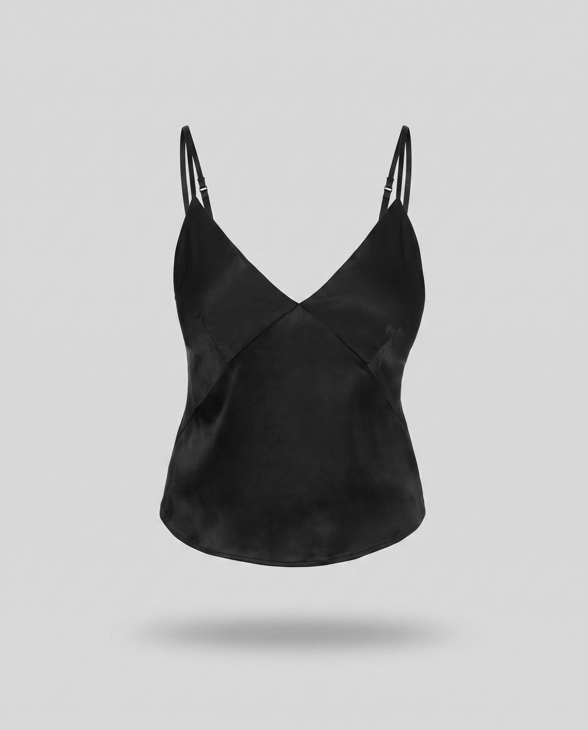 A KAYA black plant-based silk camisole on a pale grey backdrop