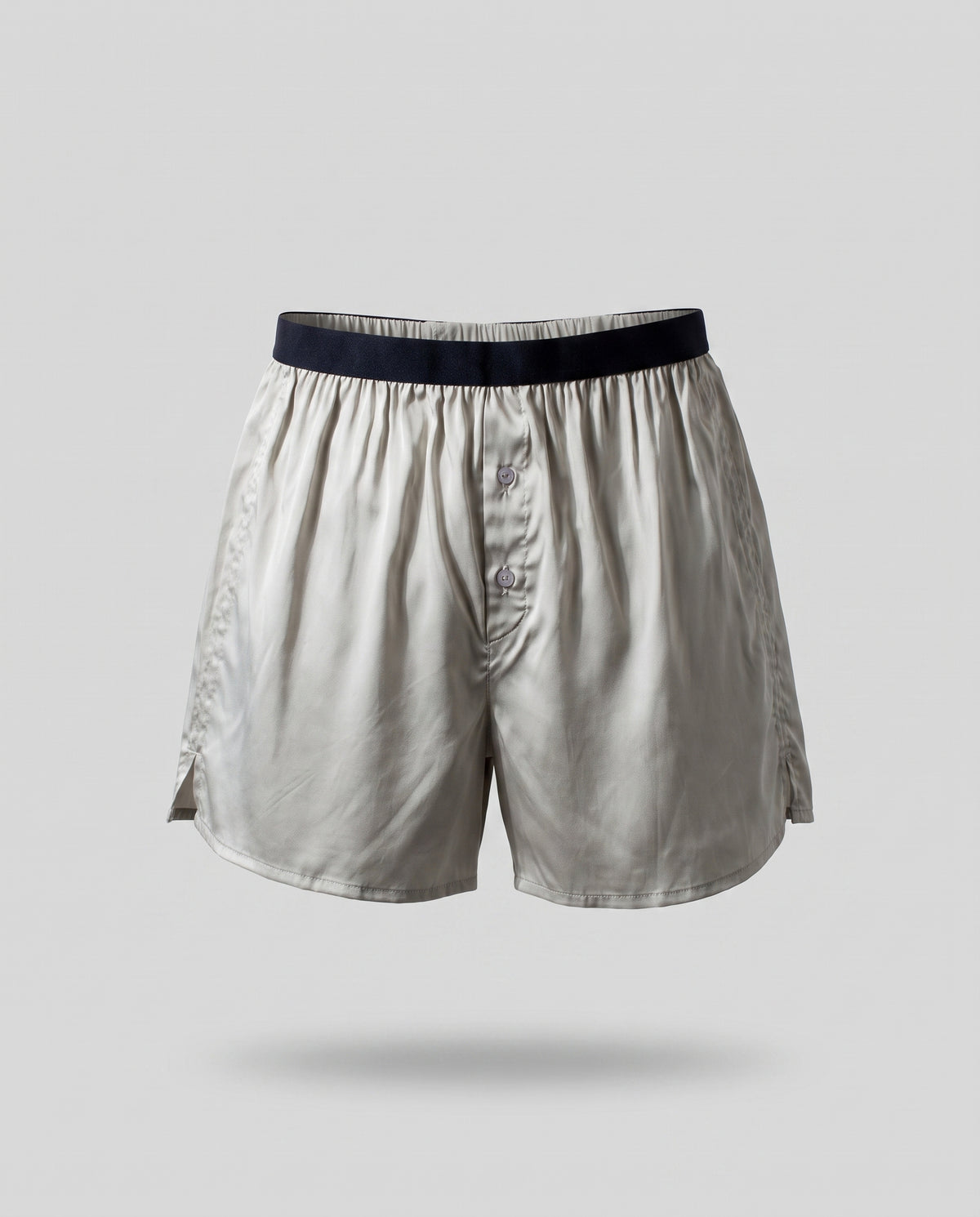A KAYA silver plant-based silk boxer on a pale grey backdrop