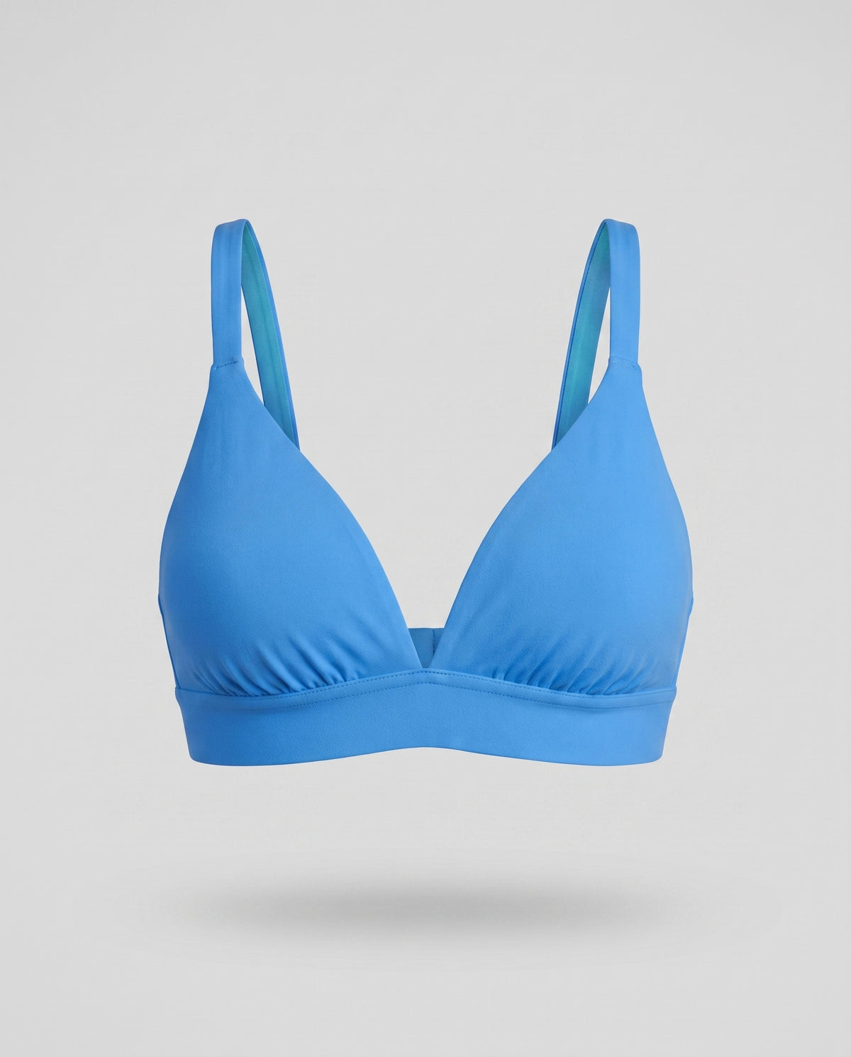 A KAYA blue plain cotton triangle bra on a pale grey backdrop