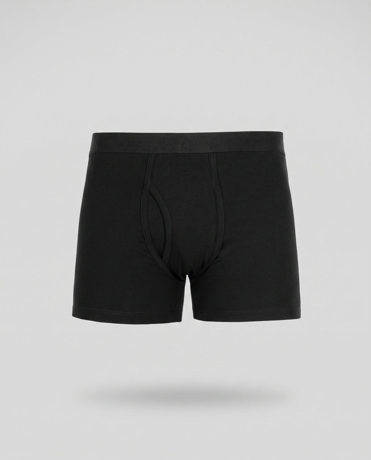 A KAYA black seamed cotton trunk on a pale grey backdrop
