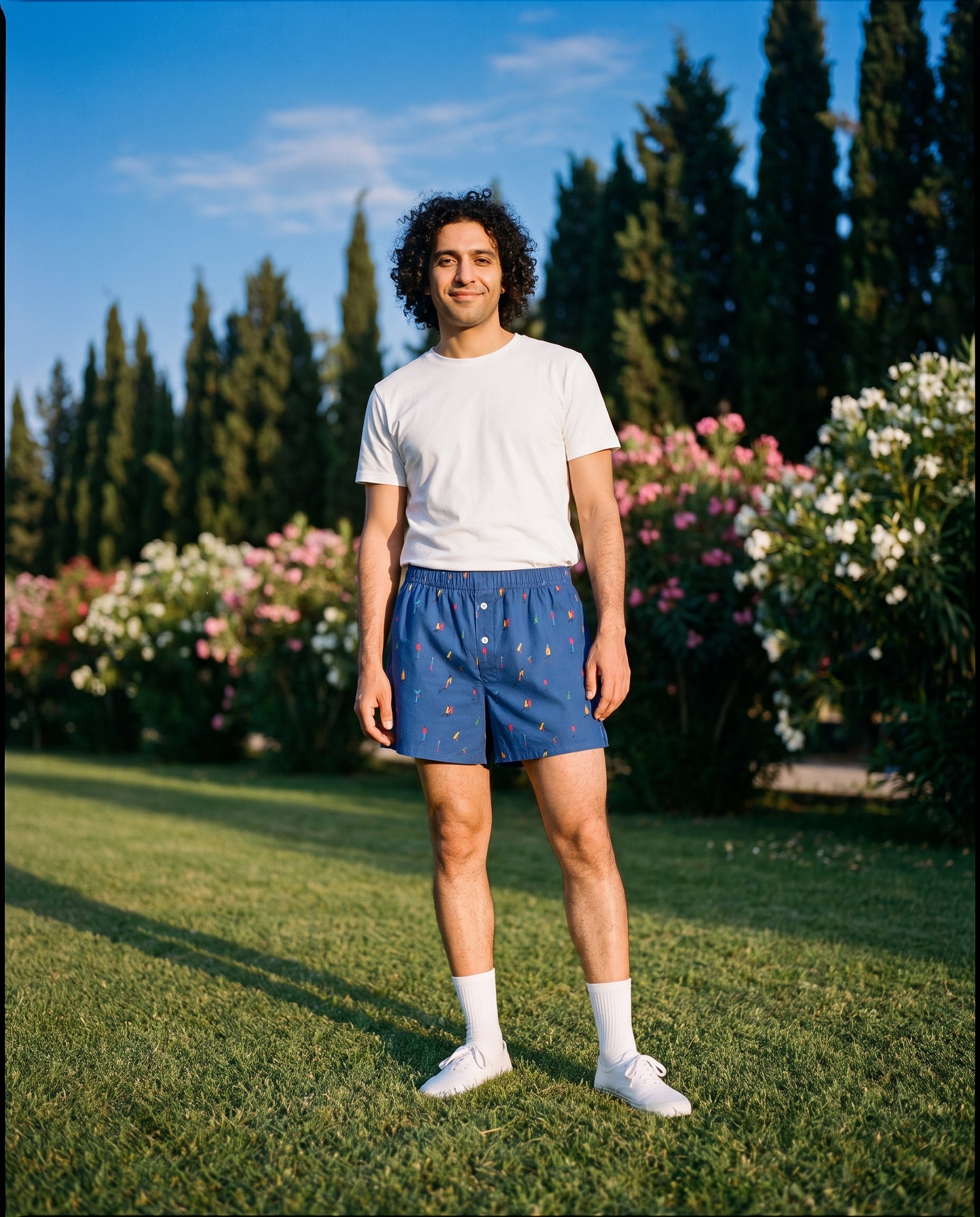 The KAYA x Mulehet cotton boxer in Classic Blue, worn on a lawn at golden hour