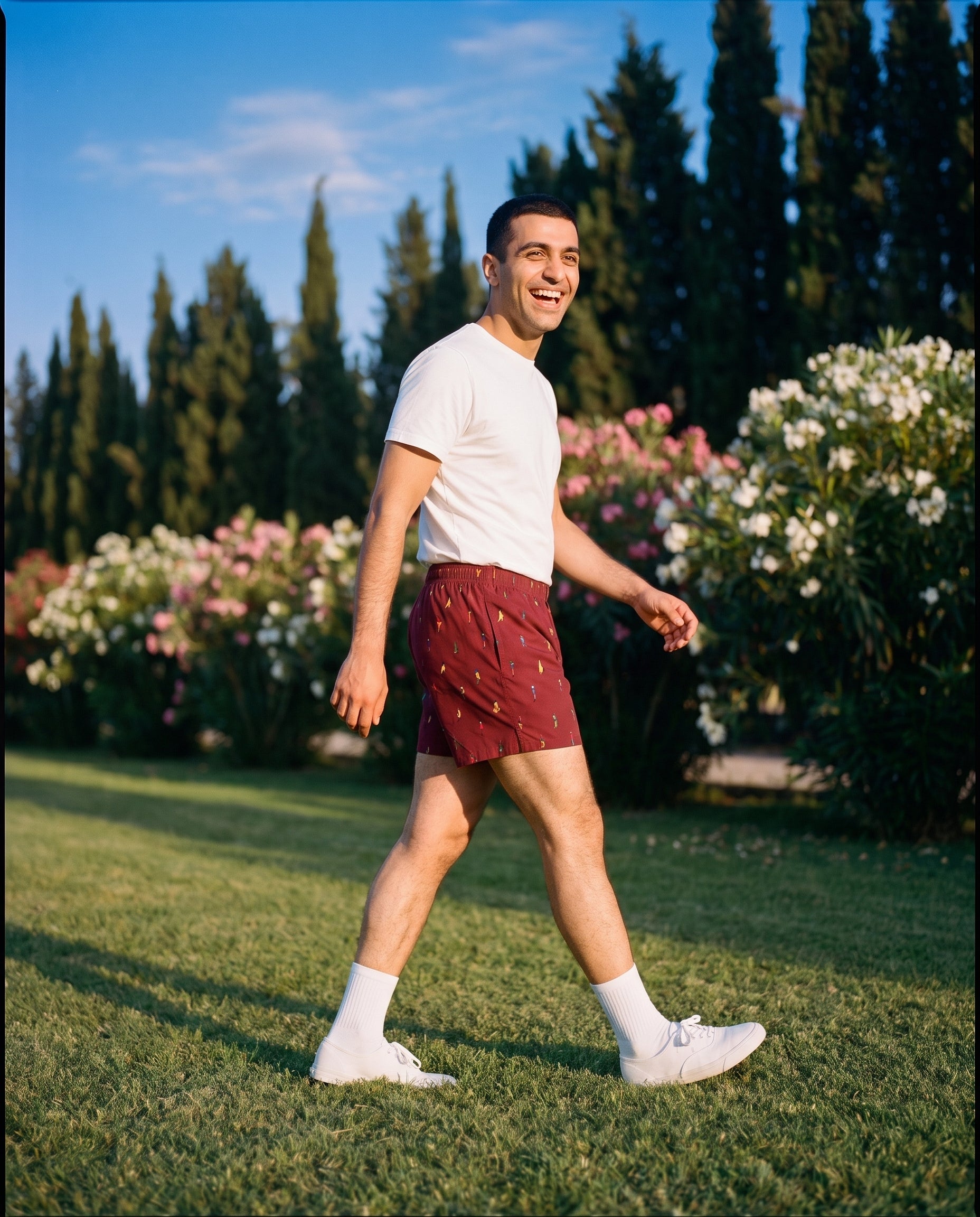 The KAYA x Mulehet cotton boxer in Brick Red, worn on a lawn at golden hour